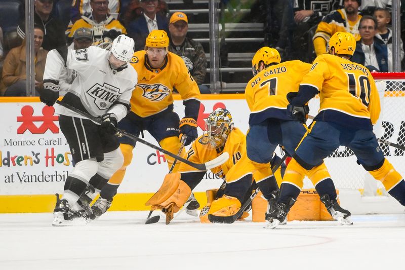 Nov 4, 2024; Nashville, Tennessee, USA;  Nashville Predators goaltender Juuse Saros (74) blocks the deflection from Los Angeles Kings left wing Warren Foegele (37) during the first period at Bridgestone Arena. Mandatory Credit: Steve Roberts-Imagn Images