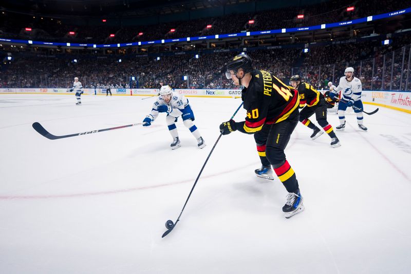 Dec 12, 2023; Vancouver, British Columbia, CAN; Tampa Bay Lightning forward Brandon Hagel (38) watches as Vancouver Canucks forward Elias Pettersson (40) passes the puck in the third period at Rogers Arena. Vancouver won 4-1. Mandatory Credit: Bob Frid-USA TODAY Sports