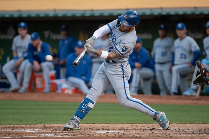 Aug 22, 2023; Oakland, California, USA; Kansas City Royals center fielder Kyle Isbel (28) hits an RBI single during the second inning against the Oakland Athletics at Oakland-Alameda County Coliseum. Mandatory Credit: Ed Szczepanski-USA TODAY Sports