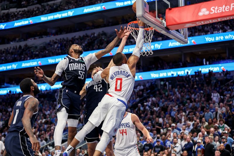 DALLAS, TEXAS - APRIL 28: Russell Westbrook #0 of the Los Angeles Clippers goes up for a lay up while defended by Derrick Jones Jr. #55 of the Dallas Mavericks and Maxi Kleber #42 in the second half of game four of the Western Conference First Round Playoffs at American Airlines Center on April 28, 2024 in Dallas, Texas.  NOTE TO USER: User expressly acknowledges and agrees that, by downloading and or using this photograph, User is consenting to the terms and conditions of the Getty Images License Agreement. (Photo by Tim Warner/Getty Images)