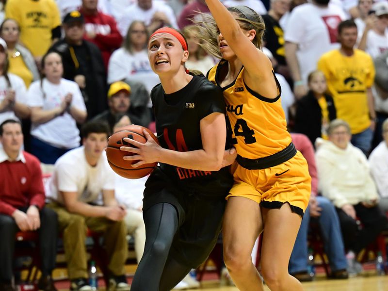 Feb 22, 2024; Bloomington, Indiana, USA; Indiana Hoosiers guard Sara Scalia (14) pushes past Iowa Hawkeyes guard Gabbie Marshall (24) during the second half at Simon Skjodt Assembly Hall. Mandatory Credit: Marc Lebryk-USA TODAY Sports