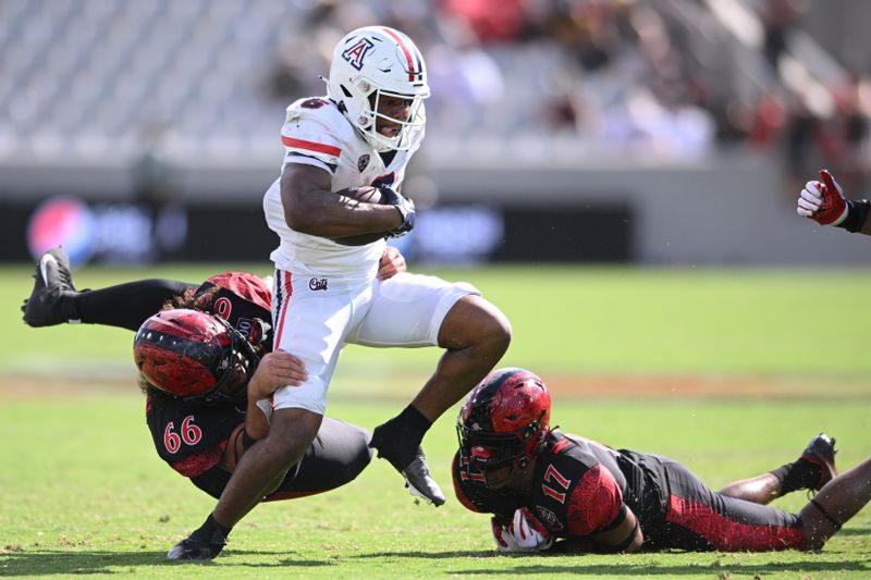 Sep 3, 2022; San Diego, California, USA; Arizona Wildcats running back Michael Wiley (6) is tackled by San Diego State Aztecs defensive lineman Jonah Tavai (66) during the second half at Snapdragon Stadium. Mandatory Credit: Orlando Ramirez-USA TODAY Sports