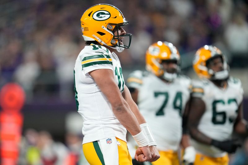 Green Bay Packers' Jordan Love reacts after throwing a touchdown pass during the first half of an NFL football game against the Minnesota Vikings Sunday, Dec. 31, 2023, in Minneapolis. (AP Photo/Abbie Parr)