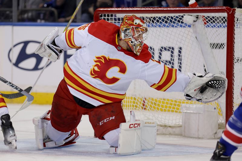 Feb 12, 2024; New York, New York, USA; Calgary Flames goaltender Jacob Markstrom (25) makes a save against the New York Rangers during the first period at Madison Square Garden. Mandatory Credit: Brad Penner-USA TODAY Sports