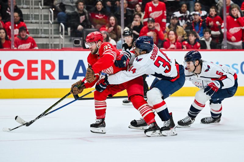 Dec 21, 2025; Detroit, Michigan, USA; Detroit Red Wings right wing Alex Debrincat (93) brings the puck up ice against Washington Capitals right wing Justin Sourdif (34) and defenseman Jakob Chychrun (6) during overtime at Little Caesars Arena. Mandatory Credit: Tim Fuller-Imagn Images