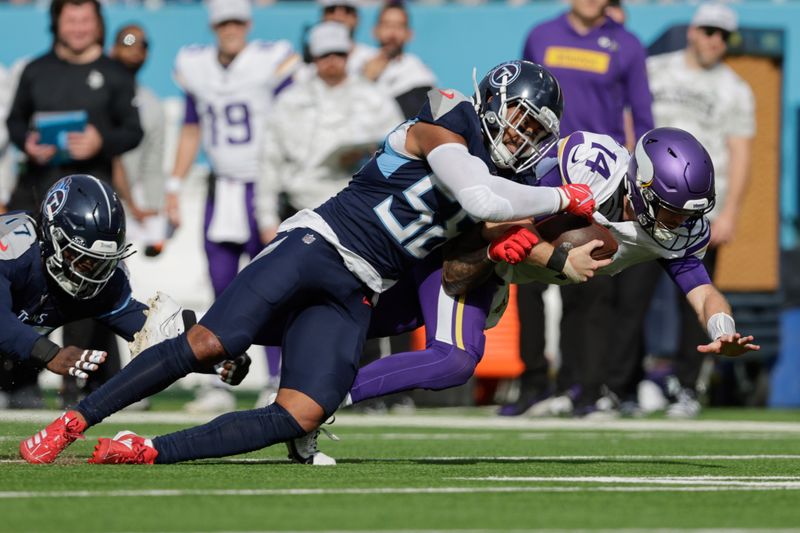 Minnesota Vikings quarterback Sam Darnold (14) is tackled by Tennessee Titans outside linebacker Harold Landry III (58) during the first half of an NFL football game, Sunday, Nov. 17, 2024, in Nashville, Tenn. (AP Photo/Stew Milne)