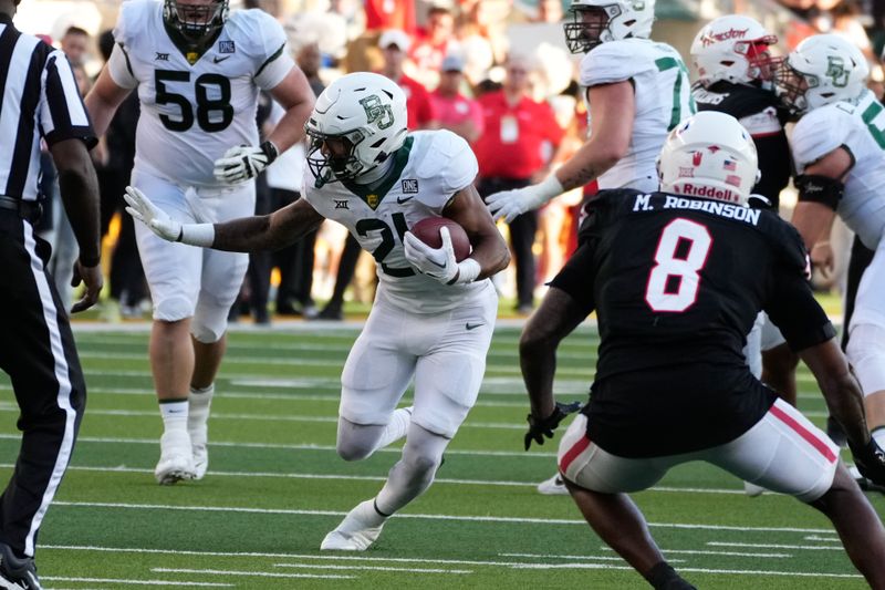 Nov 4, 2023; Waco, Texas, USA;  Baylor Bears running back Dominic Richardson (21) runs the ball against Houston Cougars linebacker Malik Robinson (8) during the second half at McLane Stadium. Mandatory Credit: Chris Jones-USA TODAY Sports