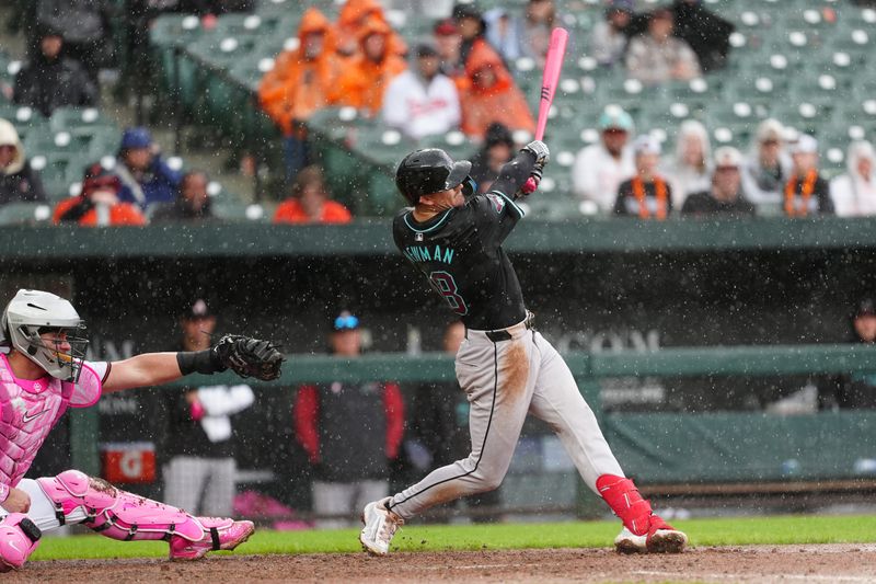 May 12, 2024; Baltimore, Maryland, USA; Arizona Diamondbacks shortstop Kevin Newman (18) hits a double against the Baltimore Orioles during the seventh inning at Oriole Park at Camden Yards. Mandatory Credit: Gregory Fisher-USA TODAY Sports