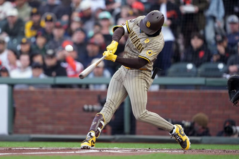 Apr 6, 2024; San Francisco, California, USA; San Diego Padres left fielder Jurickson Profar (10) hits a grand slam home run against the San Francisco Giants during the first inning at Oracle Park. Mandatory Credit: Darren Yamashita-USA TODAY Sports