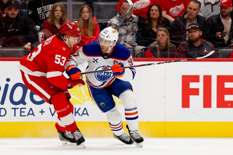 Oct 19, 2025; Detroit, Michigan, USA;  Detroit Red Wings defenseman Moritz Seider (53) vies for position against  Edmonton Oilers center Connor McDavid (97) in the first period at Little Caesars Arena. Mandatory Credit: Rick Osentoski-Imagn Images