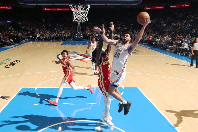 OKLAHOMA CITY, OK - OCTOBER 17: Ajay Mitchell #25 of the Oklahoma City Thunder drives to the basket during the game Atlanta Hawks on October 17, 2024 at Paycom Arena in Oklahoma City, Oklahoma. NOTE TO USER: User expressly acknowledges and agrees that, by downloading and or using this photograph, User is consenting to the terms and conditions of the Getty Images License Agreement. Mandatory Copyright Notice: Copyright 2024 NBAE (Photo by Zach Beeker/NBAE via Getty Images)