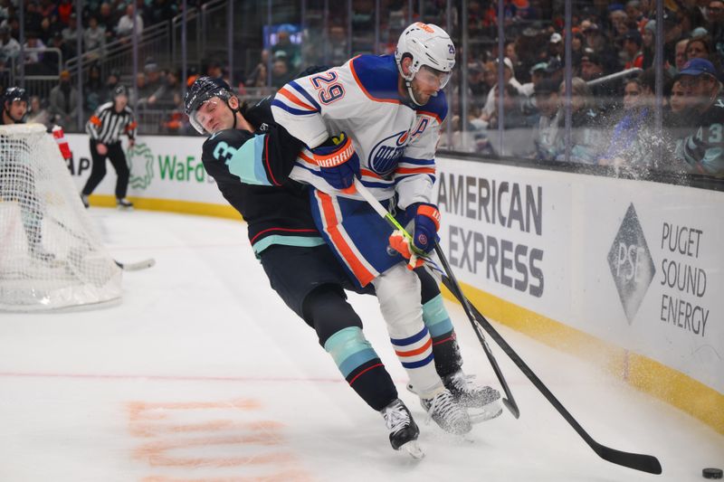 Mar 2, 2024; Seattle, Washington, USA; Edmonton Oilers center Leon Draisaitl (29) plays the puck while defended by Seattle Kraken defenseman Will Borgen (3) during the first period at Climate Pledge Arena. Mandatory Credit: Steven Bisig-USA TODAY Sports