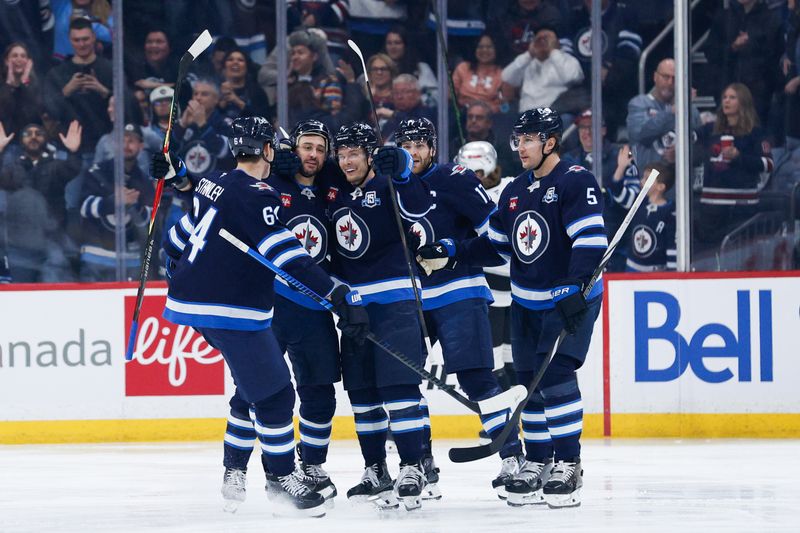 Jan 9, 2026; Winnipeg, Manitoba, CAN;  Winnipeg Jets forward Vladislav Namestnikov (7) is congratulated by his team mates on his goal against the Los Angeles Kings during the first period at Canada Life Centre. Mandatory Credit: Terrence Lee-Imagn Images
