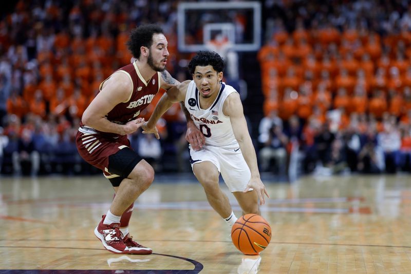 Jan 28, 2023; Charlottesville, Virginia, USA; Virginia Cavaliers guard Kihei Clark (0) drives to the basket as Boston College Eagles guard Jaeden Zackery (3) defends in the second half at John Paul Jones Arena. Mandatory Credit: Geoff Burke-USA TODAY Sports