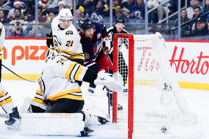 Dec 11, 2025; Winnipeg, Manitoba, CAN;  Winnipeg Jets forward Gabriel Vilardi (13) scores on Boston Bruins goalie Joonas Jorpisalo (70) during the second period at Canada Life Centre. Mandatory Credit: Terrence Lee-Imagn Images