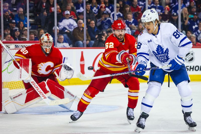 Jan 18, 2024; Calgary, Alberta, CAN; Toronto Maple Leafs right wing William Nylander (88) and Calgary Flames defenseman MacKenzie Weegar (52) battles for the puck in front of Calgary Flames goaltender Dan Vladar (80) during the third period at Scotiabank Saddledome. Mandatory Credit: Sergei Belski-USA TODAY Sports