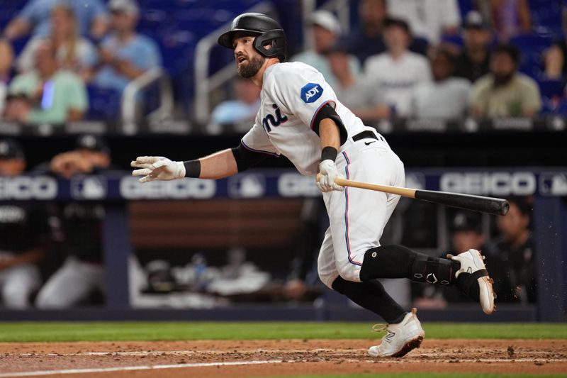 Apr 4, 2023; Miami, Florida, USA;  Miami Marlins third baseman Jon Berti (5) hits a single in the sixth inning against the Minnesota Twins at loanDepot Park. Mandatory Credit: Jim Rassol-USA TODAY Sports