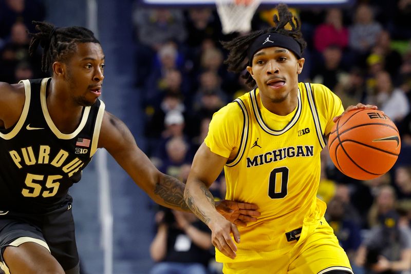 Feb 25, 2024; Ann Arbor, Michigan, USA;  Michigan Wolverines guard Dug McDaniel (0) dribbles against Purdue Boilermakers guard Lance Jones (55) in the first half at Crisler Center. Mandatory Credit: Rick Osentoski-USA TODAY Sports