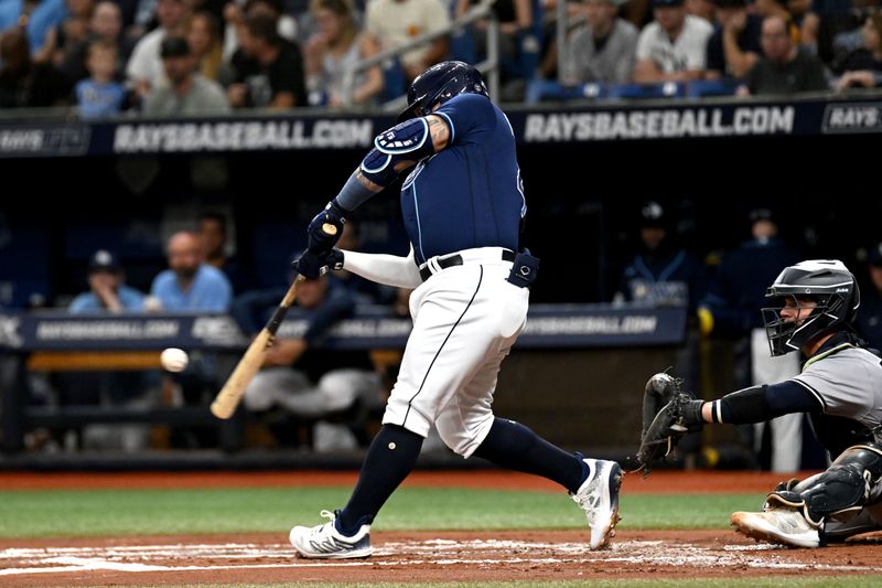 Aug 26, 2023; St. Petersburg, Florida, USA; Tampa Bay Rays designated hitter Harold Ramirez (43) hits a sacrifice fly ball against the New York Yankees in the second inning at Tropicana Field. Mandatory Credit: Jonathan Dyer-USA TODAY Sports