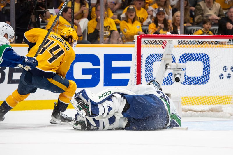 Apr 28, 2024; Nashville, Tennessee, USA; Vancouver Canucks goalie Arturs Silovs (31) blocks the shot of Nashville Predators left wing Kiefer Sherwood (44) during the second period in game four of the first round of the 2024 Stanley Cup Playoffs at Bridgestone Arena. Mandatory Credit: Steve Roberts-USA TODAY Sports