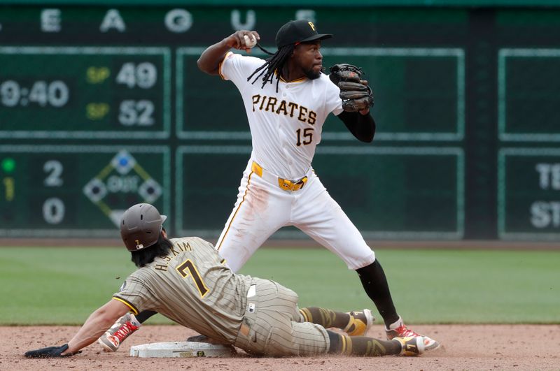 Aug 8, 2024; Pittsburgh, Pennsylvania, USA;  Pittsburgh Pirates shortstop Oneil Cruz (15) throws to first base after a force out of San Diego Padres shortstop Ha-Seong Kim (7) at second base during the ninth inning PNC Park. Mandatory Credit: Charles LeClaire-USA TODAY Sports