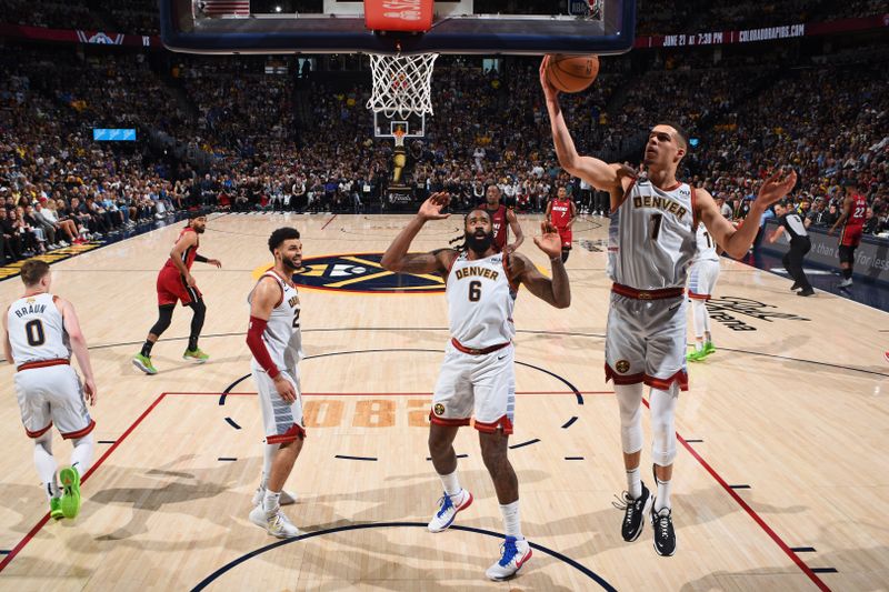 DENVER, CO - JUNE 12: Michael Porter Jr. #1 of the Denver Nuggets grabs a rebound against the Miami Heat during Game Five of the 2023 NBA Finals on June 12, 2023 at Ball Arena in Denver, Colorado. NOTE TO USER: User expressly acknowledges and agrees that, by downloading and or using this Photograph, user is consenting to the terms and conditions of the Getty Images License Agreement. Mandatory Copyright Notice: Copyright 2023 NBAE (Photo by Garrett Ellwood/NBAE via Getty Images)