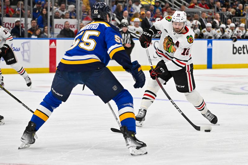 Apr 10, 2024; St. Louis, Missouri, USA;  Chicago Blackhawks center Jason Dickinson (16) shoots as St. Louis Blues defenseman Colton Parayko (55) defends during the first period at Enterprise Center. Mandatory Credit: Jeff Curry-USA TODAY Sports