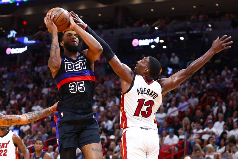 MIAMI, FLORIDA - OCTOBER 25: Marvin Bagley III #35 of the Detroit Pistons drives against Bam Adebayo #13 of the Miami Heat during the third quarter of the game at Kaseya Center on October 25, 2023 in Miami, Florida. NOTE TO USER: User expressly acknowledges and agrees that, by downloading and or using this photograph, User is consenting to the terms and conditions of the Getty Images License Agreement.  (Photo by Megan Briggs/Getty Images)