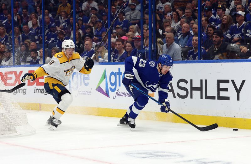 Oct 10, 2023; Tampa, Florida, USA; Tampa Bay Lightning center Michael Eyssimont (23) skates with the puck as Nashville Predators center Cody Glass (8) defends during the first period at Amalie Arena. Mandatory Credit: Kim Klement Neitzel-USA TODAY Sports