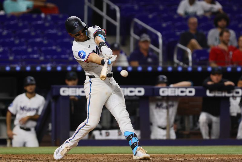 Sep 4, 2024; Miami, Florida, USA; Miami Marlins third baseman Connor Norby (24) hits a single against the Washington Nationals during the eighth inning at loanDepot Park. Mandatory Credit: Sam Navarro-Imagn Images