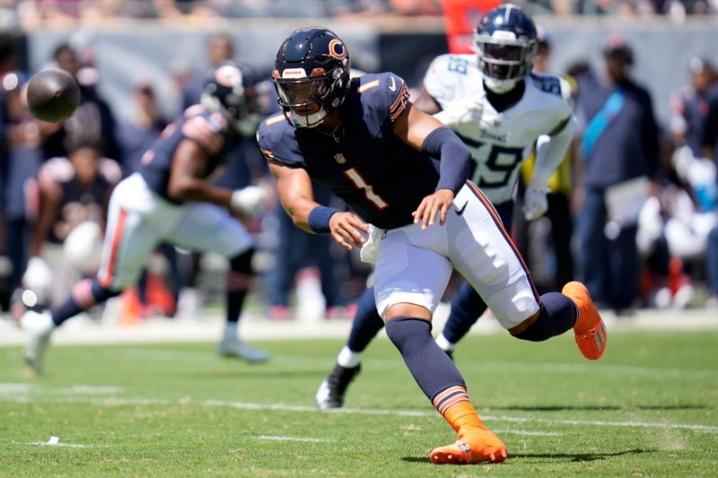 Chicago Bears quarterback Justin Fields (1) tosses the ball during the first half of an NFL preseason football game against the Tennessee Titans, Saturday, Aug. 12, 2023, in Chicago. (AP Photo/Erin Hooley)