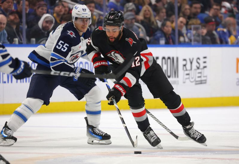 Mar 3, 2024; Buffalo, New York, USA;  Buffalo Sabres left wing Jordan Greenway (12) skates up ice with the puck during the second period against the Winnipeg Jets at KeyBank Center. Mandatory Credit: Timothy T. Ludwig-USA TODAY Sports