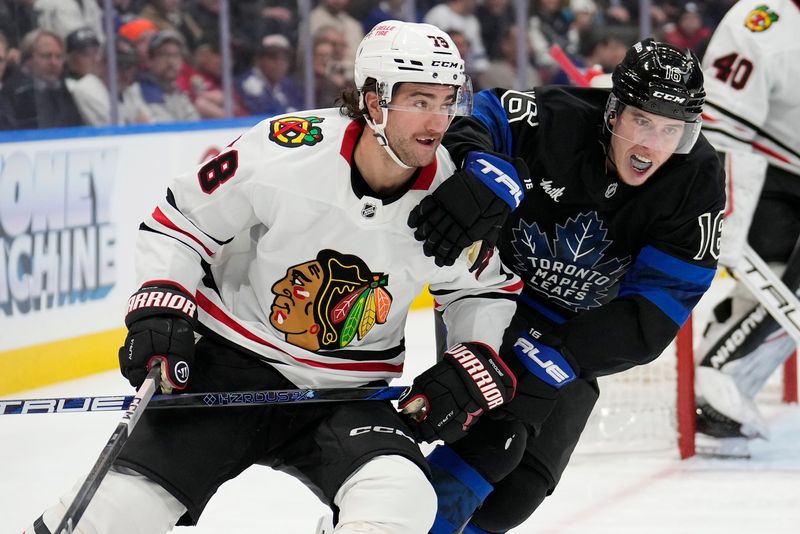 Dec 2, 2024; Toronto, Ontario, CAN; Toronto Maple Leafs forward Mitch Marner (16) and Chicago Blackhawks defenseman TJ Brodie (78) battle for position during the third period at Scotiabank Arena. Mandatory Credit: John E. Sokolowski-Imagn Images