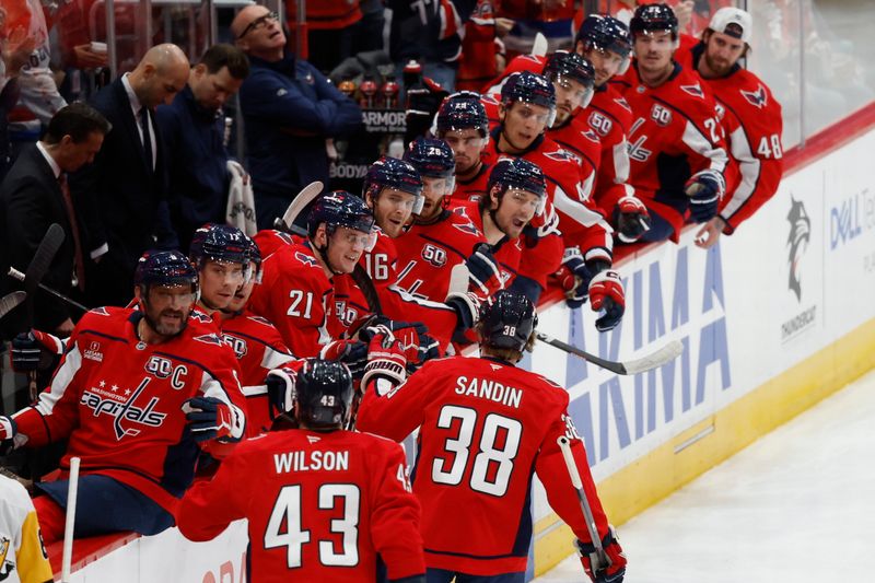 Nov 8, 2024; Washington, District of Columbia, USA; Washington Capitals defenseman Rasmus Sandin (38) celebrates with teammates after scoring a goal against the Pittsburgh Penguins in the first period at Capital One Arena. Mandatory Credit: Geoff Burke-Imagn Images