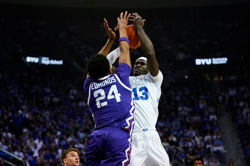 Jan 14, 2026; Provo, Utah, USA; BYU Cougars forward Keba Keita (13) takes a shot while being defended by TCU Horned Frogs forward Xavier Edmonds (24) during the first half at Marriott Center. Mandatory Credit: Aaron Baker-Imagn Images