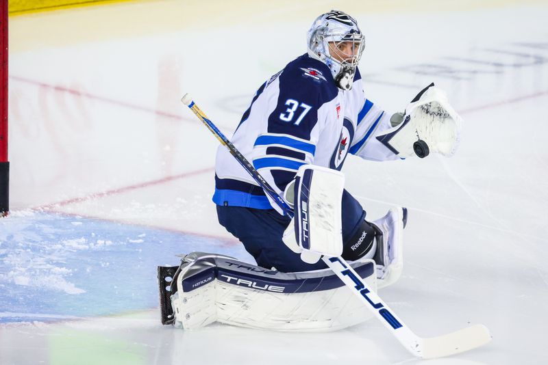 Feb 19, 2024; Calgary, Alberta, CAN; Winnipeg Jets goaltender Connor Hellebuyck (37) guards his net during the warmup period against the Calgary Flames at Scotiabank Saddledome. Mandatory Credit: Sergei Belski-USA TODAY Sports