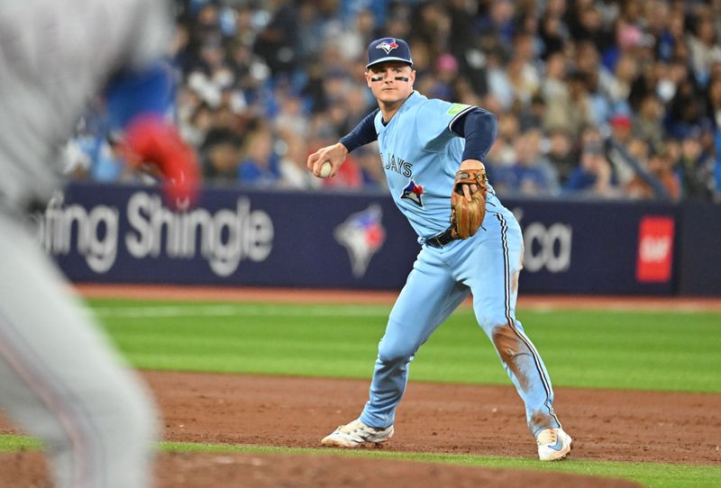 Sep 14, 2023; Toronto, Ontario, CAN;  Toronto Blue Jays third baseman Matt Chapman (26) prepares to throw out Texas Rangers designated hitter Mitch Garver (18, left) in the third inning at Rogers Centre. Mandatory Credit: Dan Hamilton-USA TODAY Sports