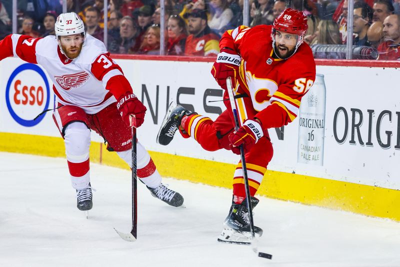 Feb 17, 2024; Calgary, Alberta, CAN; Calgary Flames defenseman Oliver Kylington (58) passes the puck against Detroit Red Wings left wing J.T. Compher (37) during the second period at Scotiabank Saddledome. Mandatory Credit: Sergei Belski-USA TODAY Sports