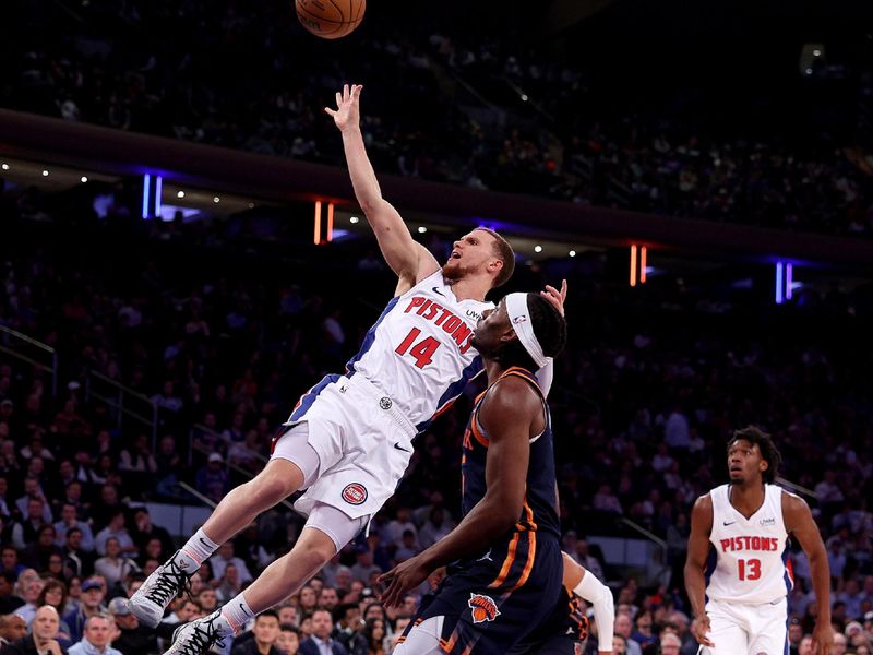 NEW YORK, NEW YORK - FEBRUARY 26: Malachi Flynn #14 of the Detroit Pistons heads for the net as Precious Achiuwa #5 of the New York Knicks defends during the first half at Madison Square Garden on February 26, 2024 in New York City. NOTE TO USER: User expressly acknowledges and agrees that, by downloading and or using this photograph, User is consenting to the terms and conditions of the Getty Images License Agreement. (Photo by Elsa/Getty Images)