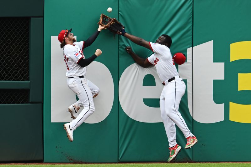 May 1, 2025; Cleveland, Ohio, USA; Cleveland Guardians center fielder Daniel Schneemann, left, and Cleveland Guardians right fielder Jhonkensy Noel go for a ball hit by Minnesota Twins center fielder Byron Buxton (not pictured) during the sixth inning at Progressive Field. Schneemann made the catch. Mandatory Credit: Ken Blaze-Imagn Images

