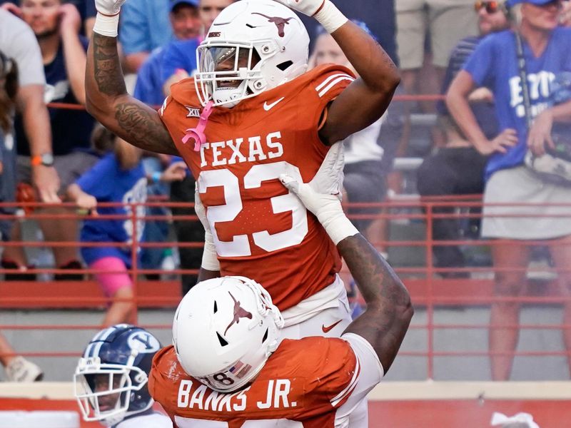 Oct 28, 2023; Austin, Texas, USA; Texas Longhorns running back Jaydon Blue (23) is lifted up by offensive lineman Kelvin Banks Jr. (78) after scoring a touchdown during the second half against the Brigham Young Cougars at Darrell K Royal-Texas Memorial Stadium. Mandatory Credit: Scott Wachter-USA TODAY Sports