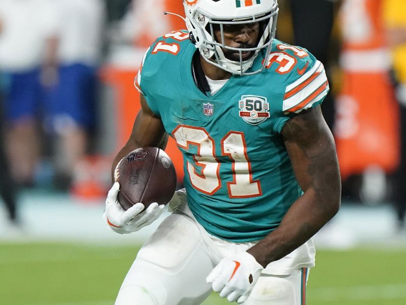 Miami Dolphins running back Raheem Mostert (31) runs a play during the first half of an NFL football game against the Pittsburgh Steelers, Sunday, Oct. 23, 2022, in Miami Gardens, Fla. (AP Photo/Wilfredo Lee )