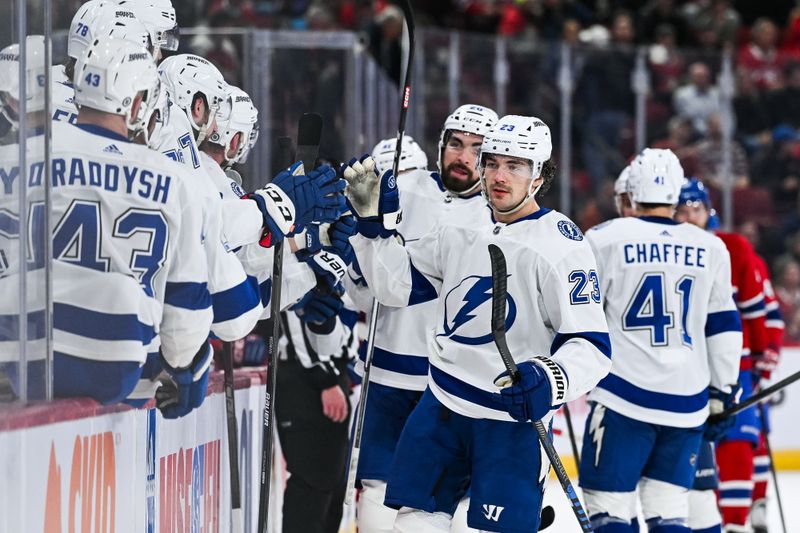 Apr 4, 2024; Montreal, Quebec, CAN; Tampa Bay Lightning center Michael Eyssimont (23) celebrates his goal against the Montreal Canadiens with his teammates at the bench during the first period at Bell Centre. Mandatory Credit: David Kirouac-USA TODAY Sports