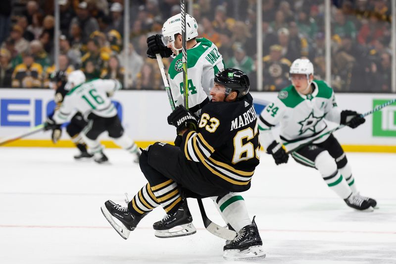 Feb 19, 2024; Boston, Massachusetts, USA; Boston Bruins left wing Brad Marchand (63) is dumped at center ice by Dallas Stars defenseman Joel Hanley (44) during the first period at TD Garden. Mandatory Credit: Winslow Townson-USA TODAY Sports