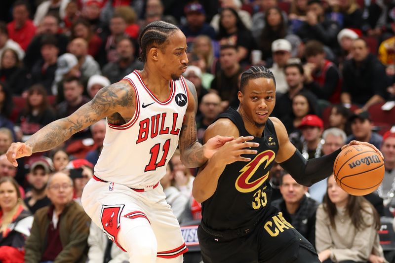 CHICAGO, ILLINOIS - DECEMBER 23: Isaac Okoro #35 of the Cleveland Cavaliers drives to the basket against DeMar DeRozan #11 of the Chicago Bulls during the first half at the United Center on December 23, 2023 in Chicago, Illinois. NOTE TO USER: User expressly acknowledges and agrees that, by downloading and or using this photograph, User is consenting to the terms and conditions of the Getty Images License Agreement.  (Photo by Michael Reaves/Getty Images)