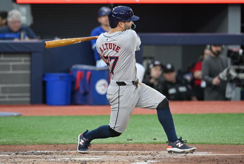 Jul 2, 2024; Toronto, Ontario, CAN;  Houston Astros second baseman Jose Altuve (27) hits an RBI single against the Toronto Blue Jays in the fifth inning at Rogers Centre. Mandatory Credit: Dan Hamilton-USA TODAY Sports
