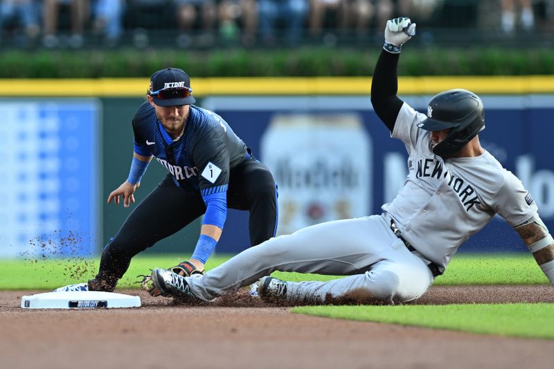 Aug 16, 2024; Detroit, Michigan, USA;  New York Yankees second baseman Gleyber Torres (25) slides safely into second base ahead of the tag from Detroit Tigers second baseman Zach McKinstry (39) after Tigers center fielder Parker Meadows (not pictured) misplayed Torres’ single in the first inning at Comerica Park. Mandatory Credit: Lon Horwedel-USA TODAY Sports