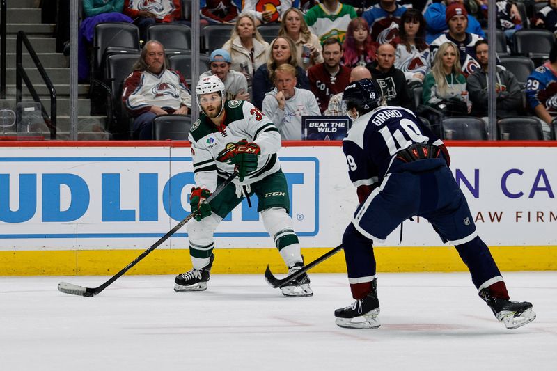 Apr 9, 2024; Denver, Colorado, USA; Minnesota Wild right wing Ryan Hartman (38) controls the puck as Colorado Avalanche defenseman Samuel Girard (49) defends in the third period at Ball Arena. Mandatory Credit: Isaiah J. Downing-USA TODAY Sports