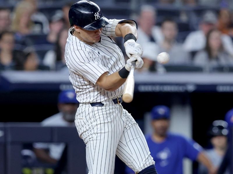 Aug 2, 2024; Bronx, New York, USA; New York Yankees shortstop Anthony Volpe (11) hits a two run home run against the Toronto Blue Jays during the fifth inning at Yankee Stadium. Mandatory Credit: Brad Penner-USA TODAY Sports