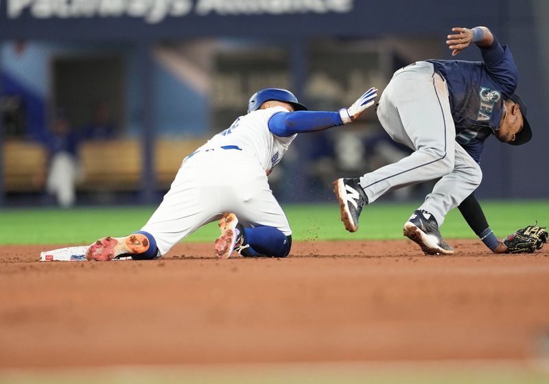 Apr 9, 2024; Toronto, Ontario, CAN; Toronto Blue Jays right fielder George Springer (4) collides with Seattle Mariners second baseman Jorge Polanco (7) during the third inning at Rogers Centre. Mandatory Credit: Nick Turchiaro-USA TODAY Sports